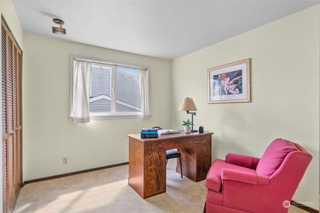 a bedroom with a bed and painting on the wall