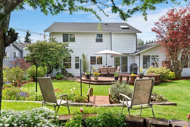 a view of a patio with chairs and potted plants