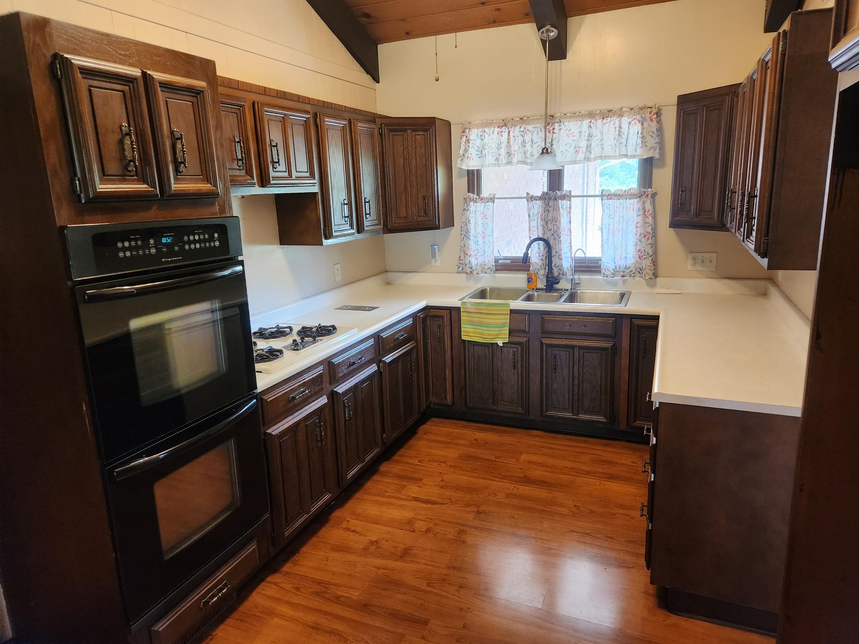 4726 Locksley Drive East Rensselaer, IN 47978 - Photo 5 of 33 a kitchen with stainless steel appliances granite countertop a stove a sink and a refrigerator