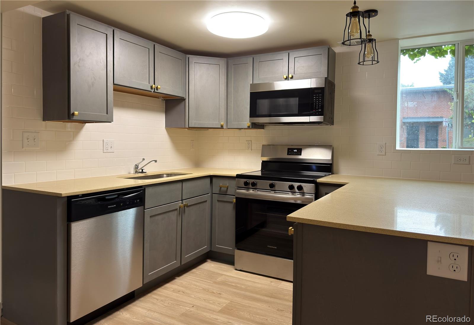 2201 South High Street, Unit 1832 Denver, CO 80210 - Photo 1 of 9 a kitchen with a sink and stainless steel appliances