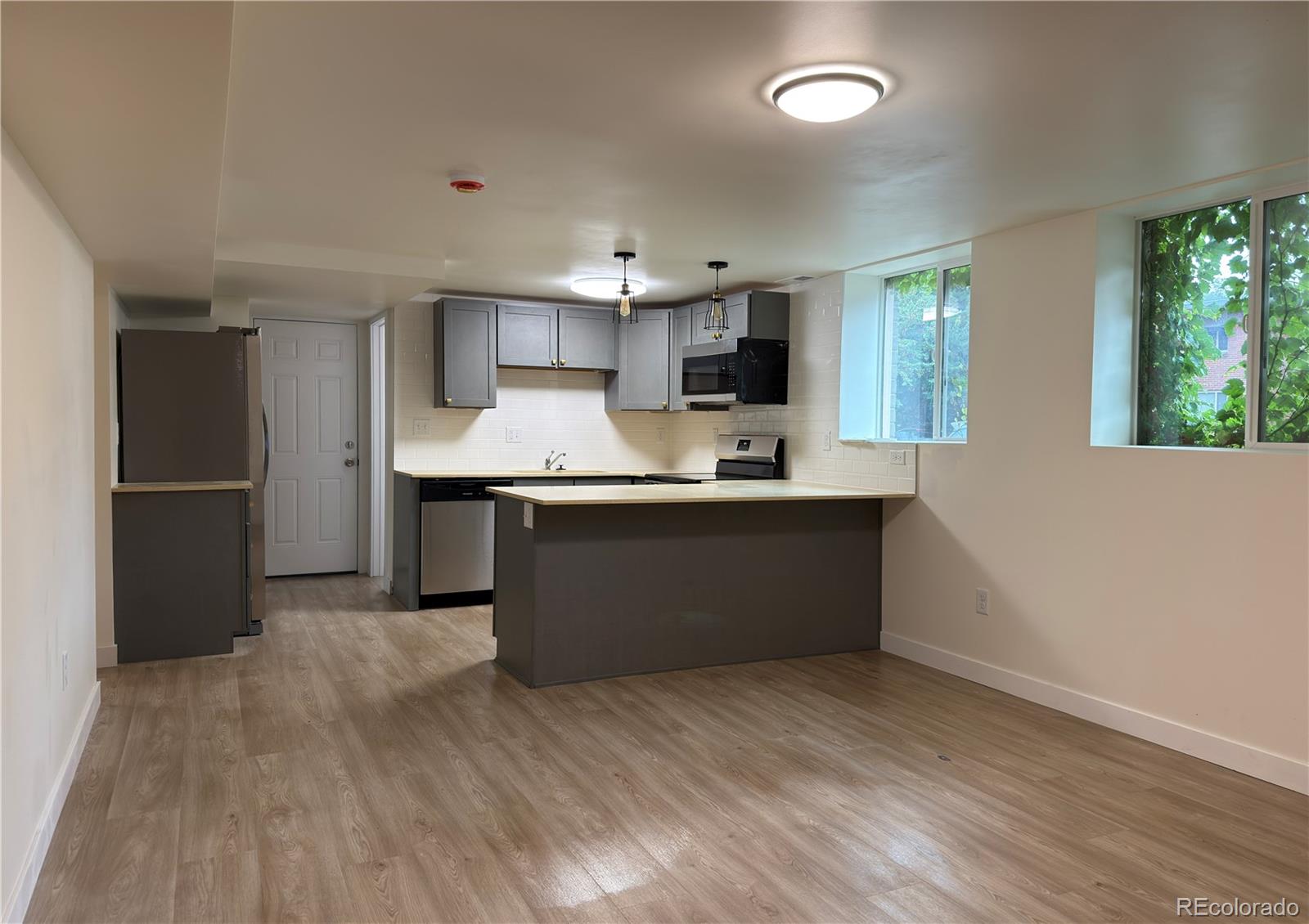 2201 South High Street, Unit 1832 Denver, CO 80210 - Photo 3 of 9 a kitchen with stainless steel appliances a sink and a refrigerator
