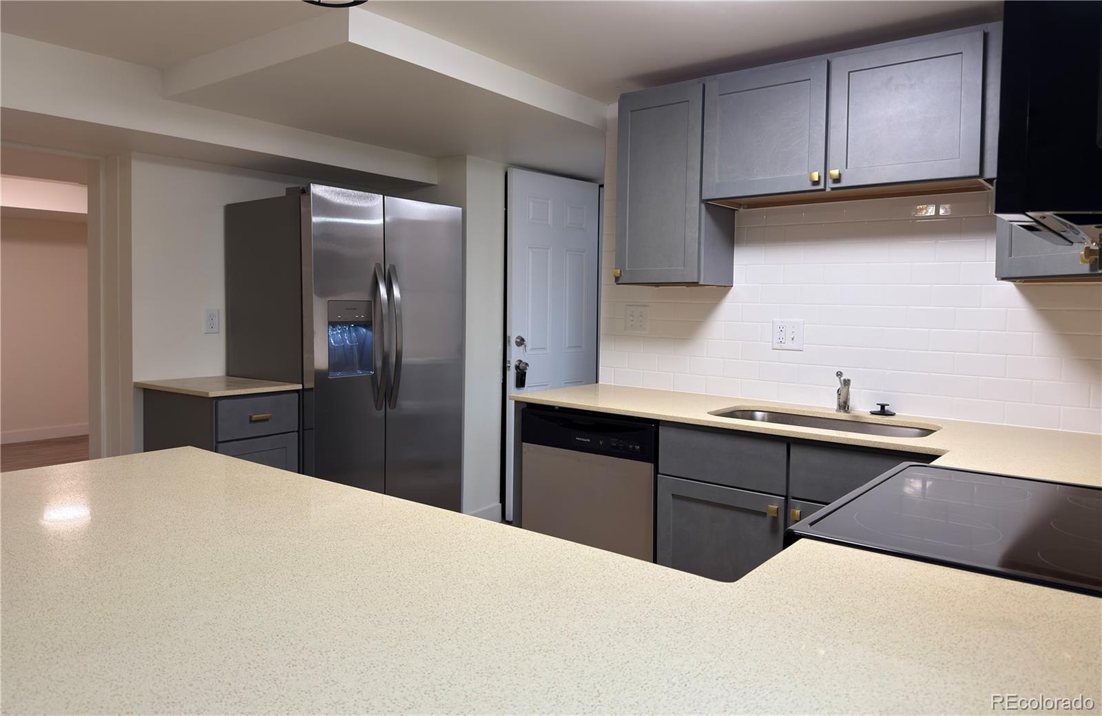 2201 South High Street, Unit 1832 Denver, CO 80210 - Photo 4 of 9 a kitchen with a refrigerator and a sink