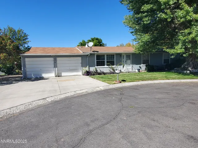 a front view of house with yard and trees