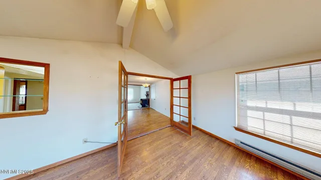 wooden floor in an empty room with a window