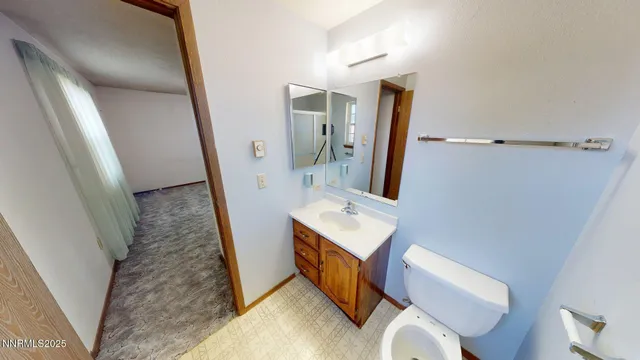 a bathroom with a sink a toilet and mirror