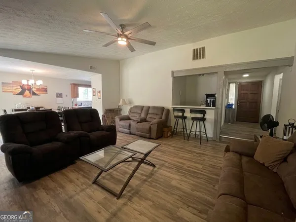 a living room with furniture and a chandelier