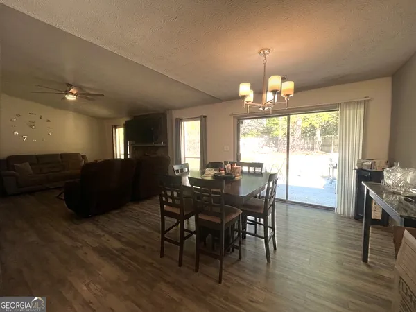 a view of a dining room with furniture window and wooden floor