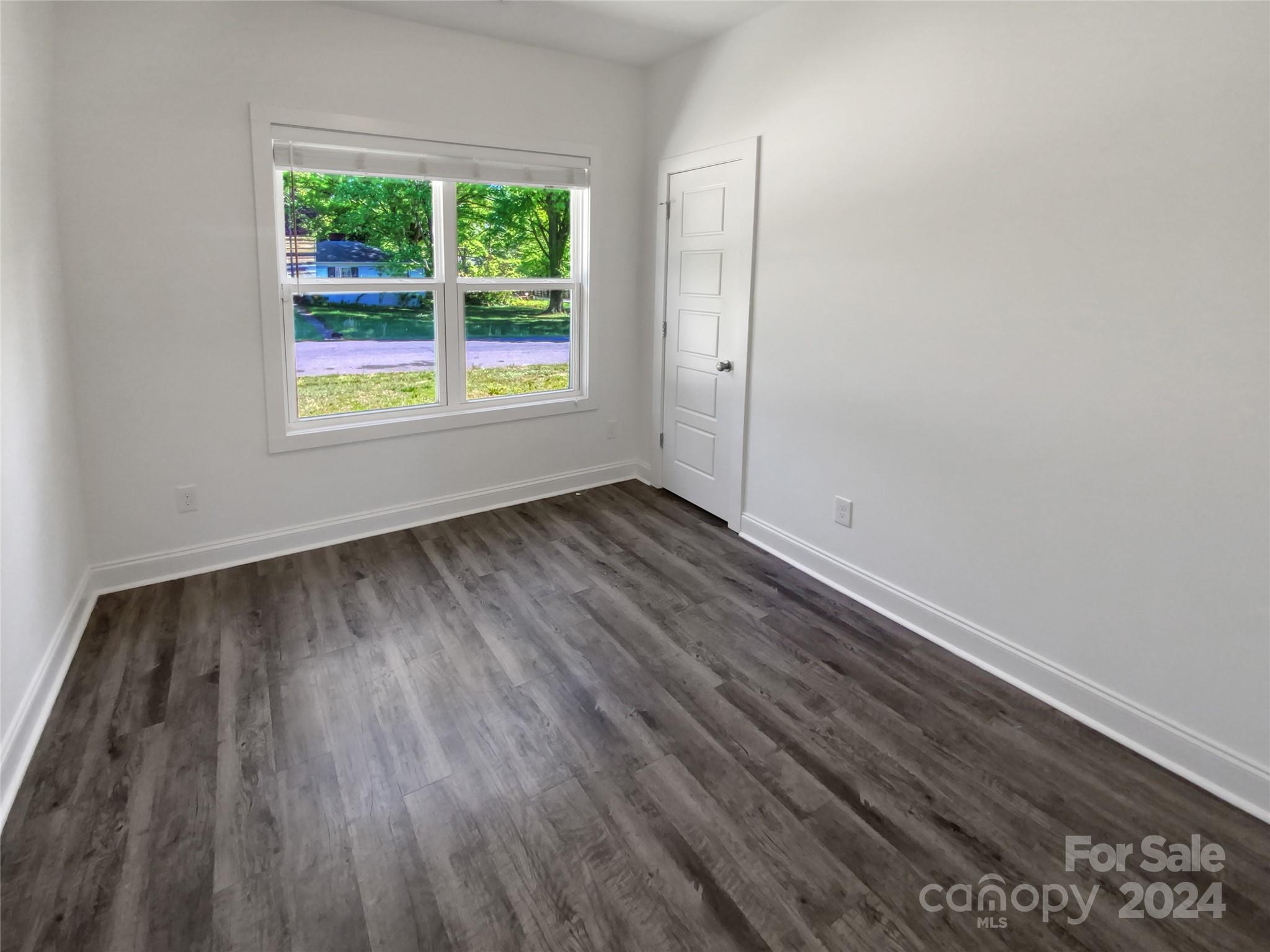 6110 Robinson Church Road Charlotte, NC 28215 - Photo 12 of 17 an empty room with wooden floor and windows