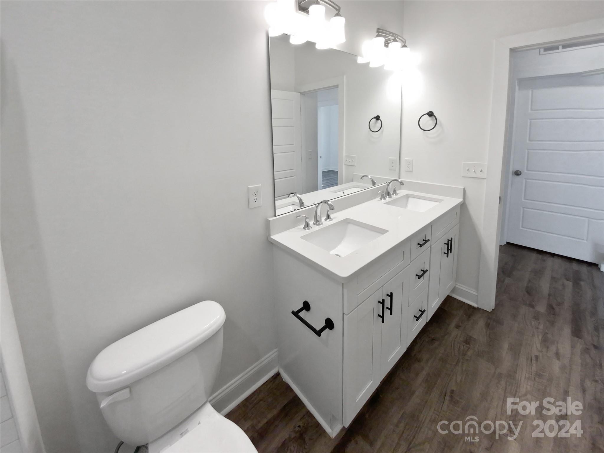 6110 Robinson Church Road Charlotte, NC 28215 - Photo 17 of 17 a spacious bathroom with a double vanity sink mirror and toilet