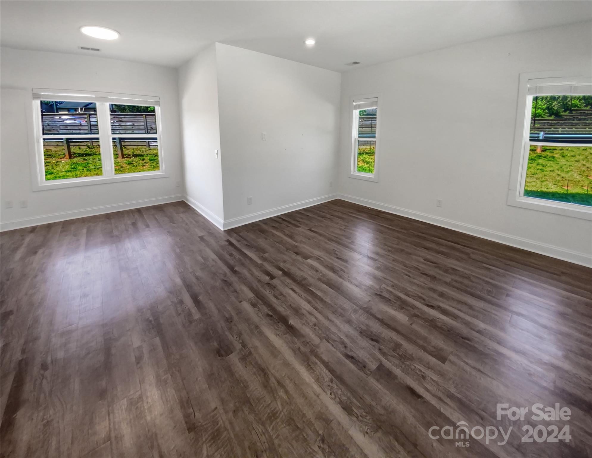 6110 Robinson Church Road Charlotte, NC 28215 - Photo 3 of 17 wooden floor in an empty room with a window