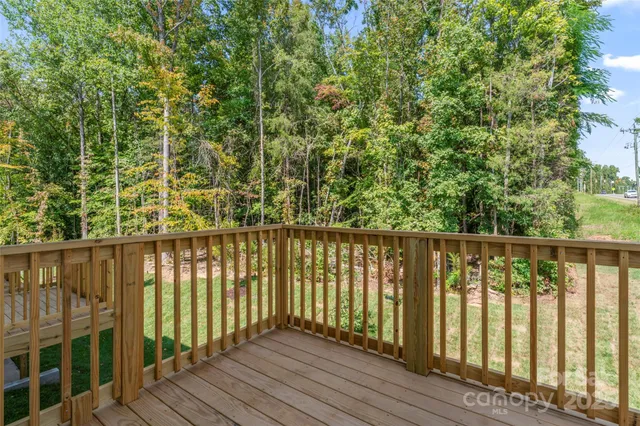 a balcony with wooden floor and fence