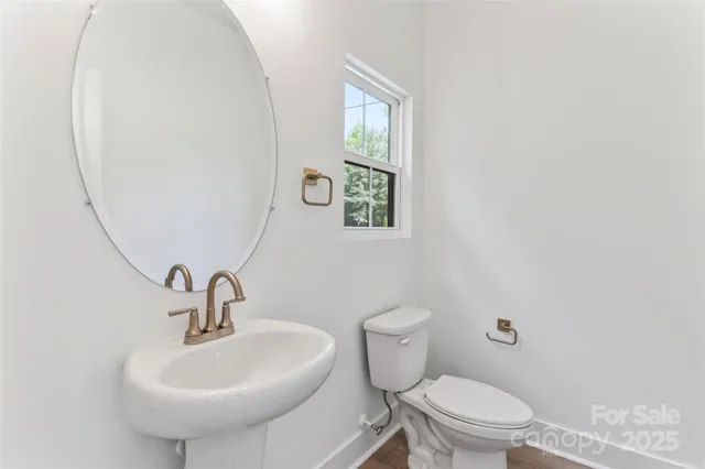 a bathroom with a sink a toilet and mirror