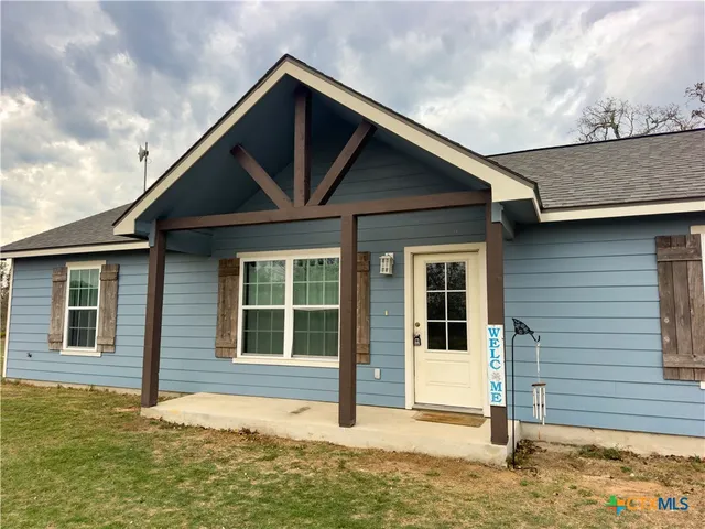 a house with trees in the background