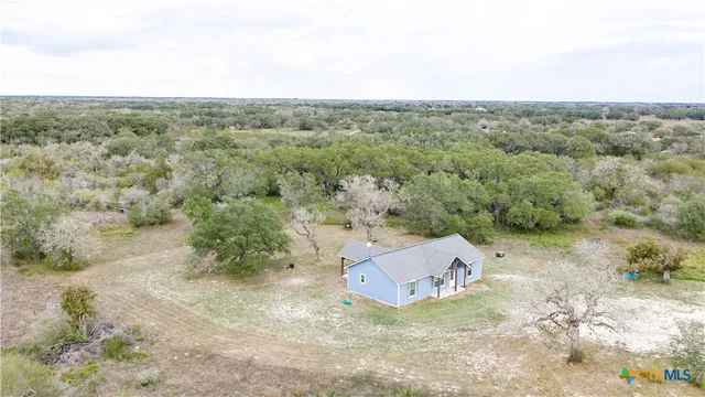 an aerial view of a house with a yard