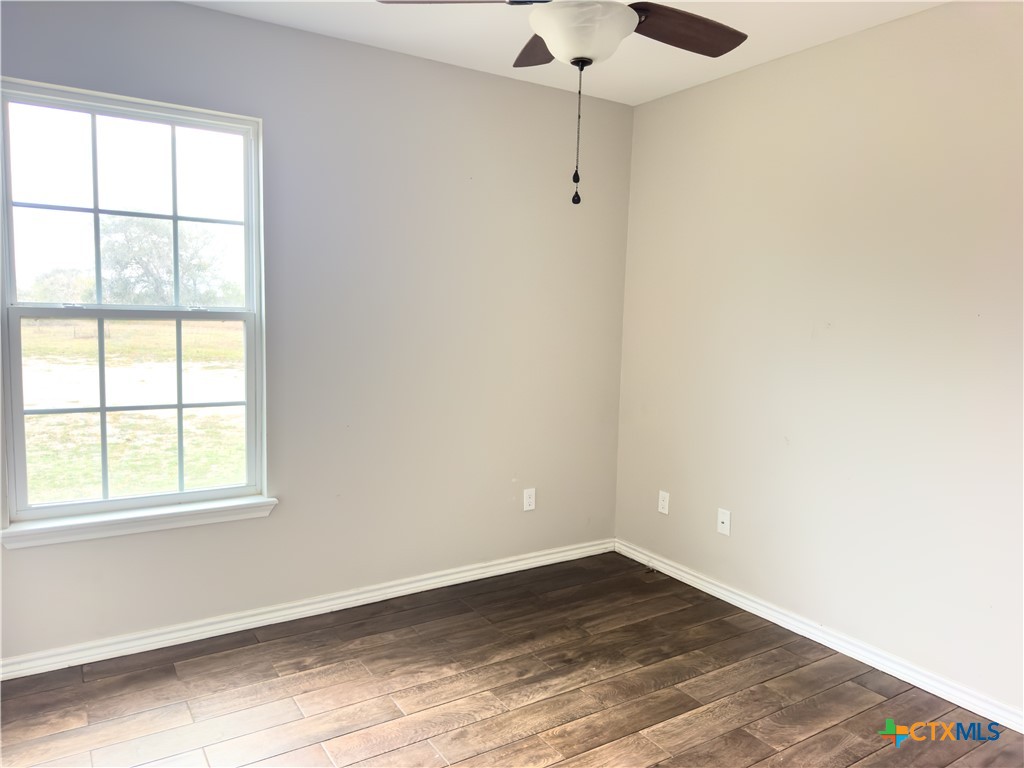 618 McGuill Road Goliad, TX 77963 - Photo 43 of 48 an empty room with wooden floor and windows