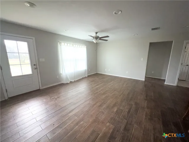 a kitchen with granite countertop a sink stove and refrigerator