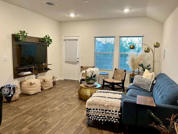 a bedroom with furniture and a flat screen tv
