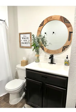 a bathroom with a sink mirror vanity and toilet