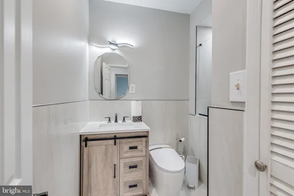 a bathroom with a sink toilet and mirror