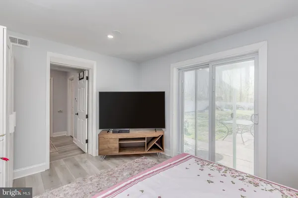 a living room with a flat screen tv and floor to ceiling window