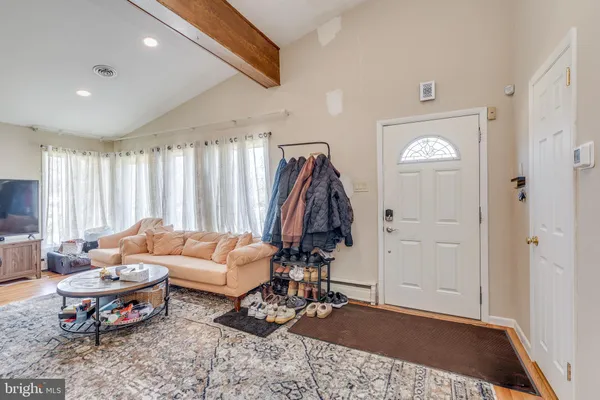 a living room with furniture a rug and a window