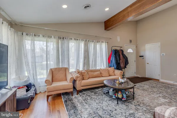 a living room with furniture a rug and a large window