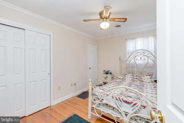 a view of a bedroom with wooden floor