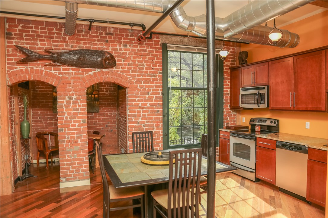 99 Allen Street, Unit 118 Woonsocket, RI 02895 - Photo 10 of 38 Another view of the kitchen and dining area with the small brick-walled nook, repurposed from the original mill building, that provides office space, a breakfast area or a bar; whatever you want!