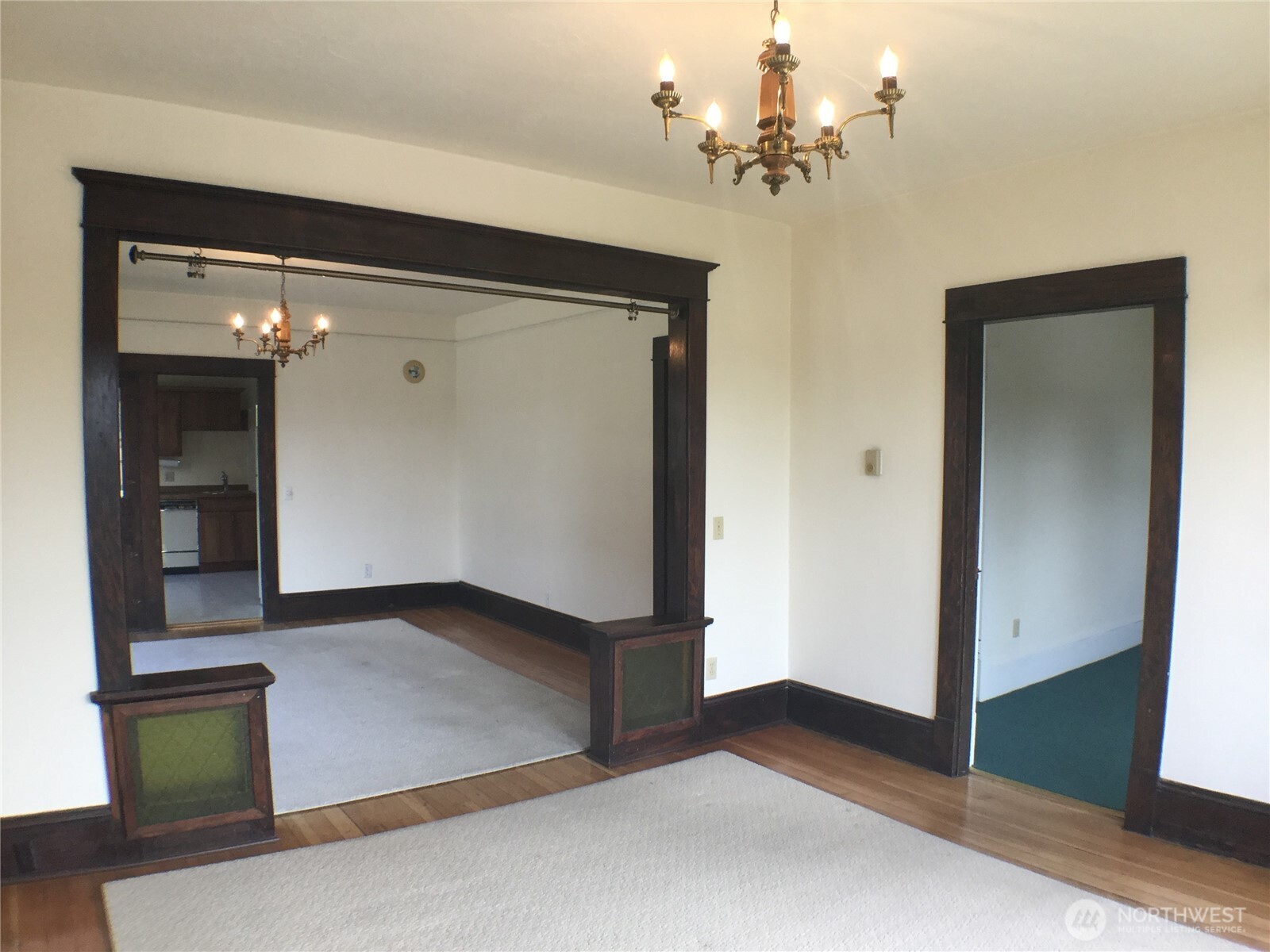 910 Northwest 52nd Street Seattle, WA 98107 - Photo 4 of 22 wooden floor in an empty room with a mirror