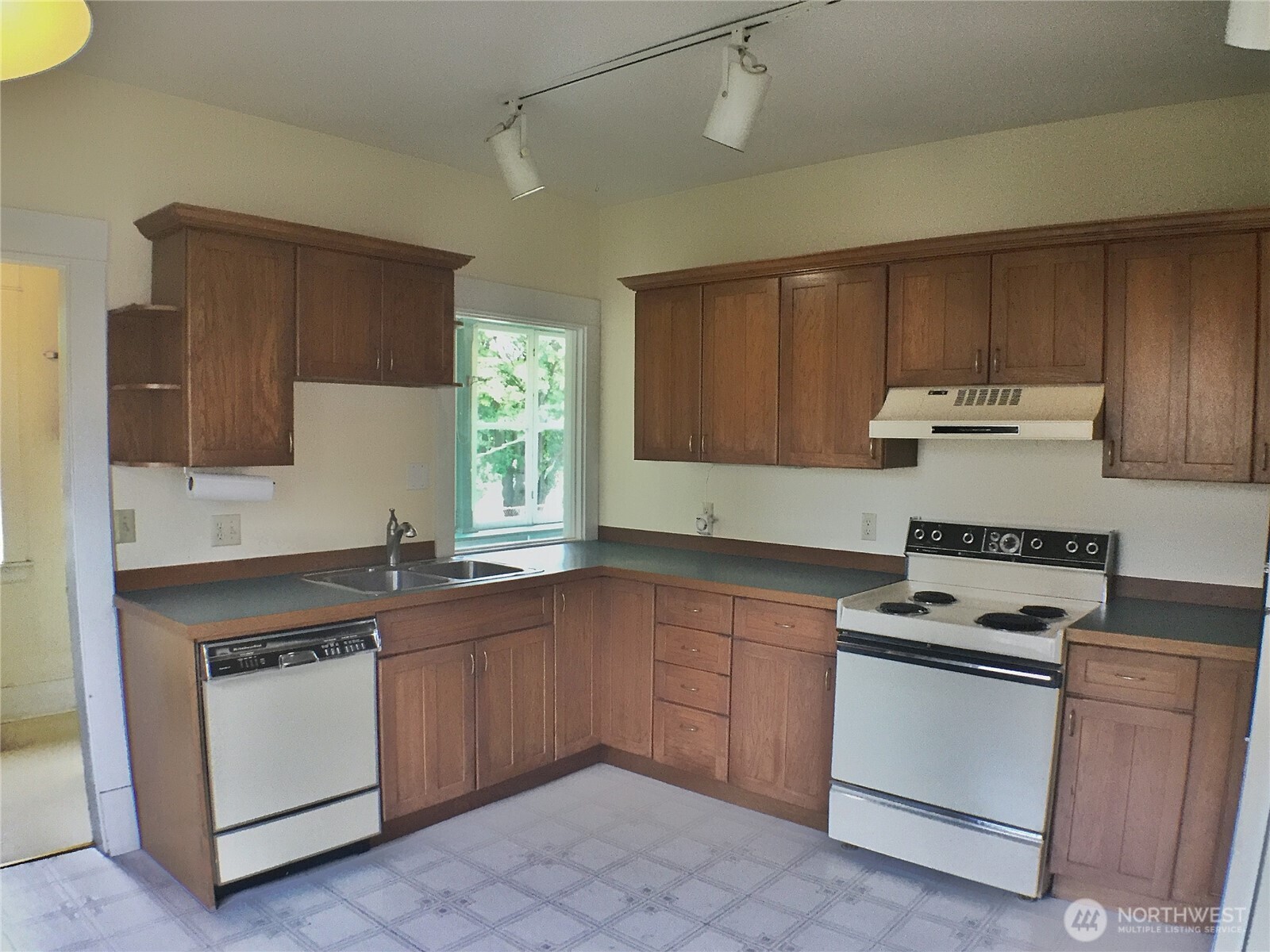 910 Northwest 52nd Street Seattle, WA 98107 - Photo 9 of 22 a kitchen with granite countertop a sink stove and cabinets