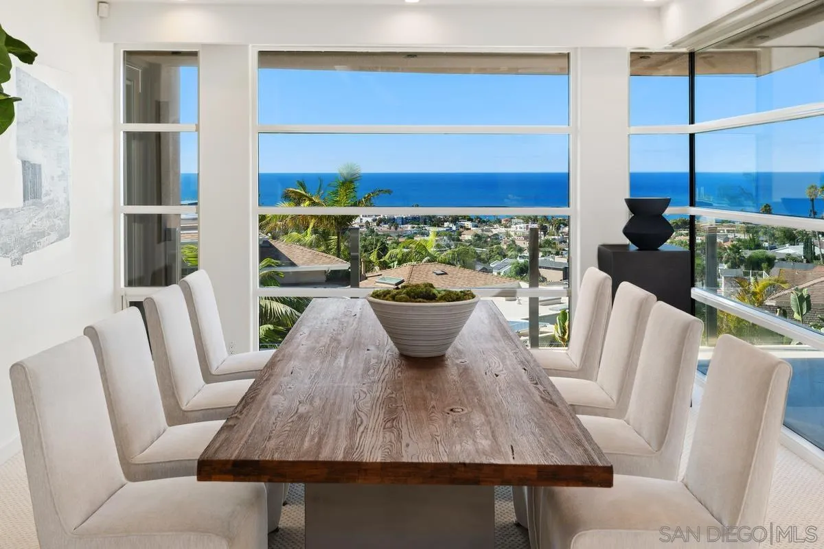 5486 Rutgers Road La Jolla, CA 92037 - Photo 11 of 47 a view of a dining room with furniture a potted plant and wooden floor