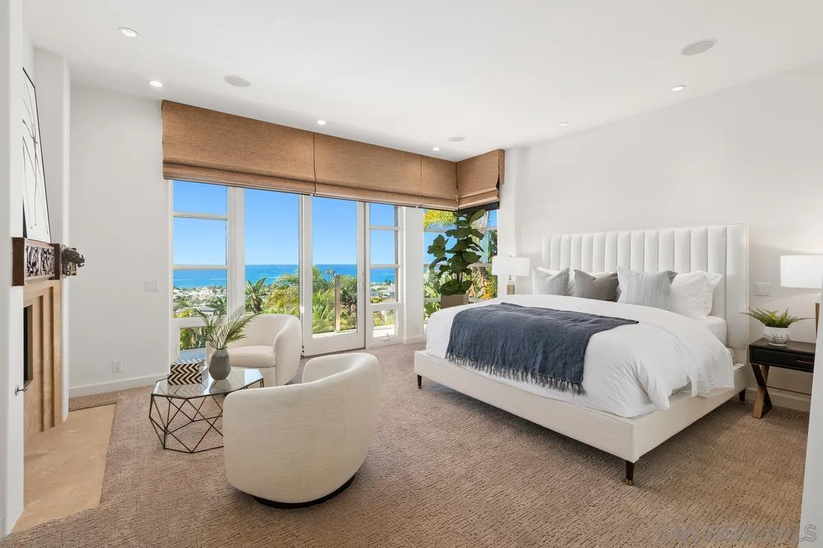 5486 Rutgers Road La Jolla, CA 92037 - Photo 16 of 47 a spacious bedroom with a bed and a large window