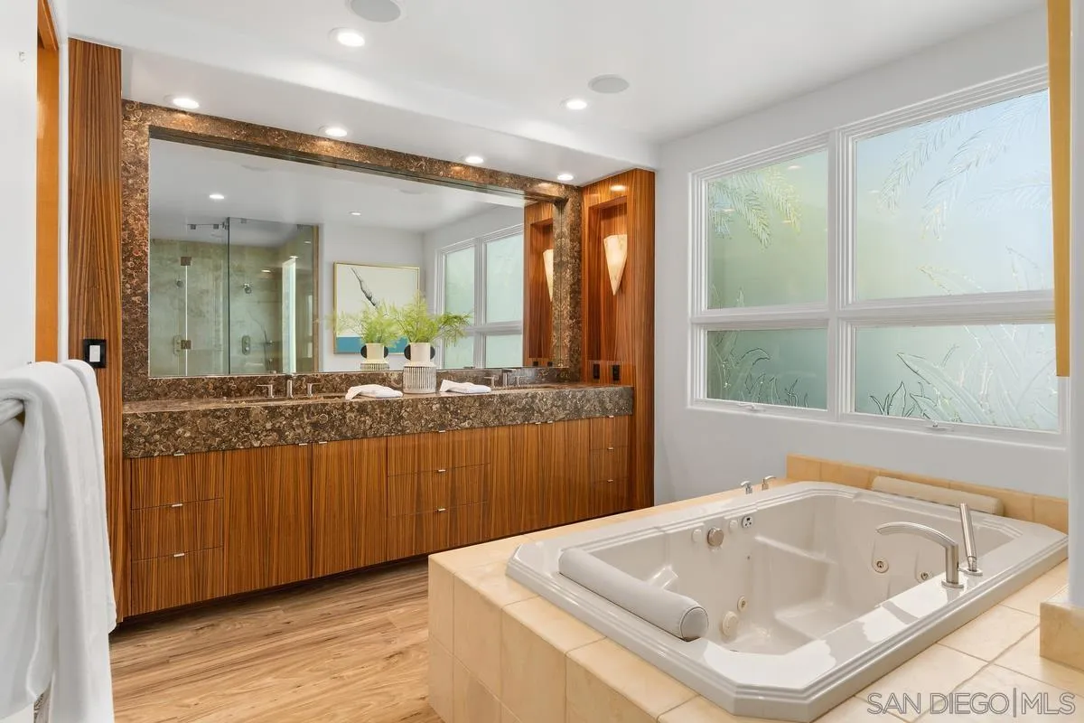 5486 Rutgers Road La Jolla, CA 92037 - Photo 18 of 47 a bathroom with a tub sink and mirror
