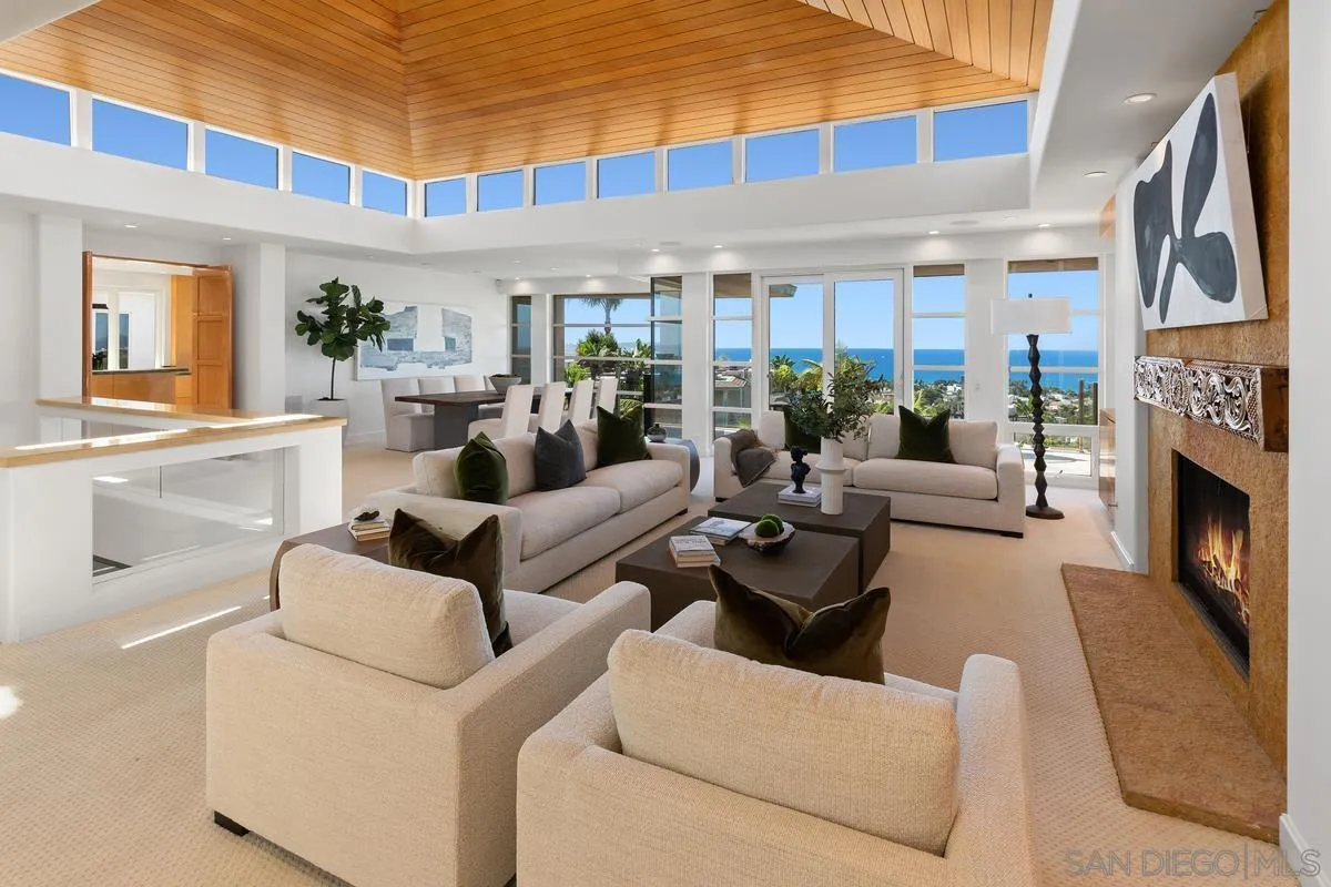 5486 Rutgers Road La Jolla, CA 92037 - Photo 7 of 47 a living room with furniture a fireplace and a large window