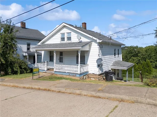 a front view of a house with a garden and porch