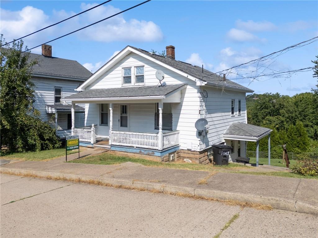 a front view of a house with a garden and porch