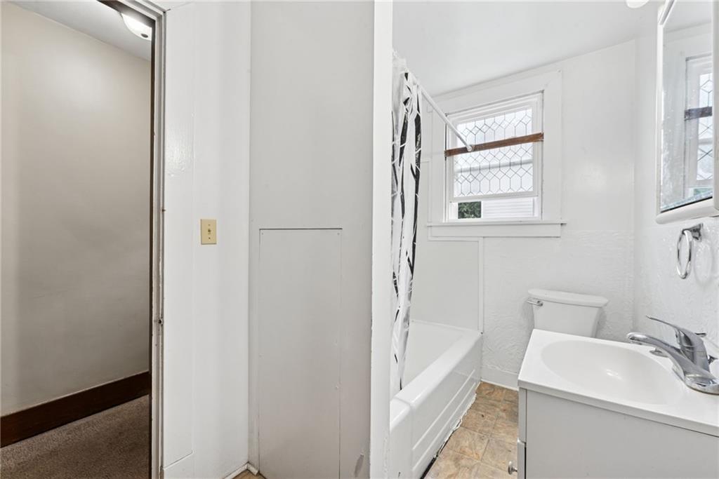 1442 Rostraver Street Monessen, PA 15062 - Photo 19 of 29 a bathroom with a sink a toilet and shower