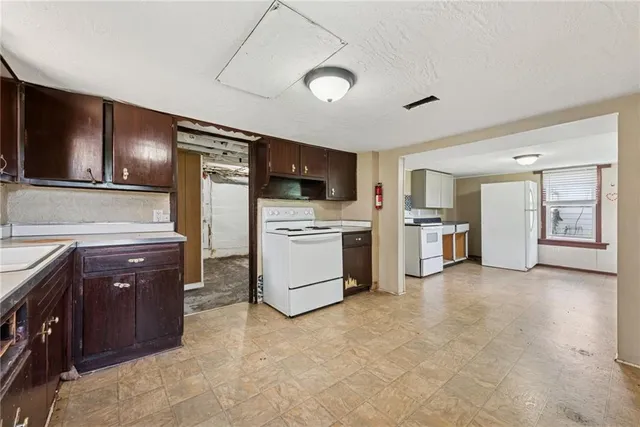 a kitchen with stainless steel appliances a refrigerator and a stove top oven