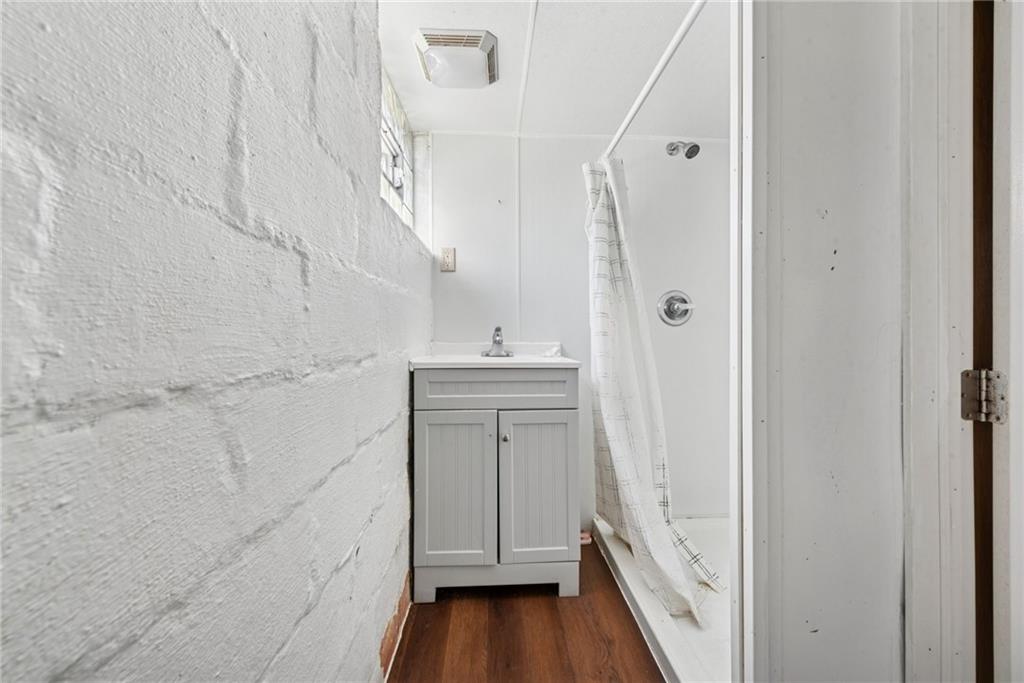 1442 Rostraver Street Monessen, PA 15062 - Photo 29 of 29 a bathroom with a sink a toilet and shower