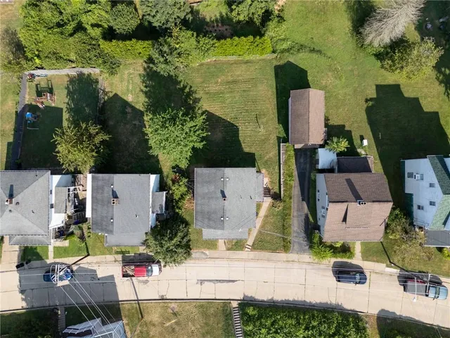 an aerial view of multiple houses with yard