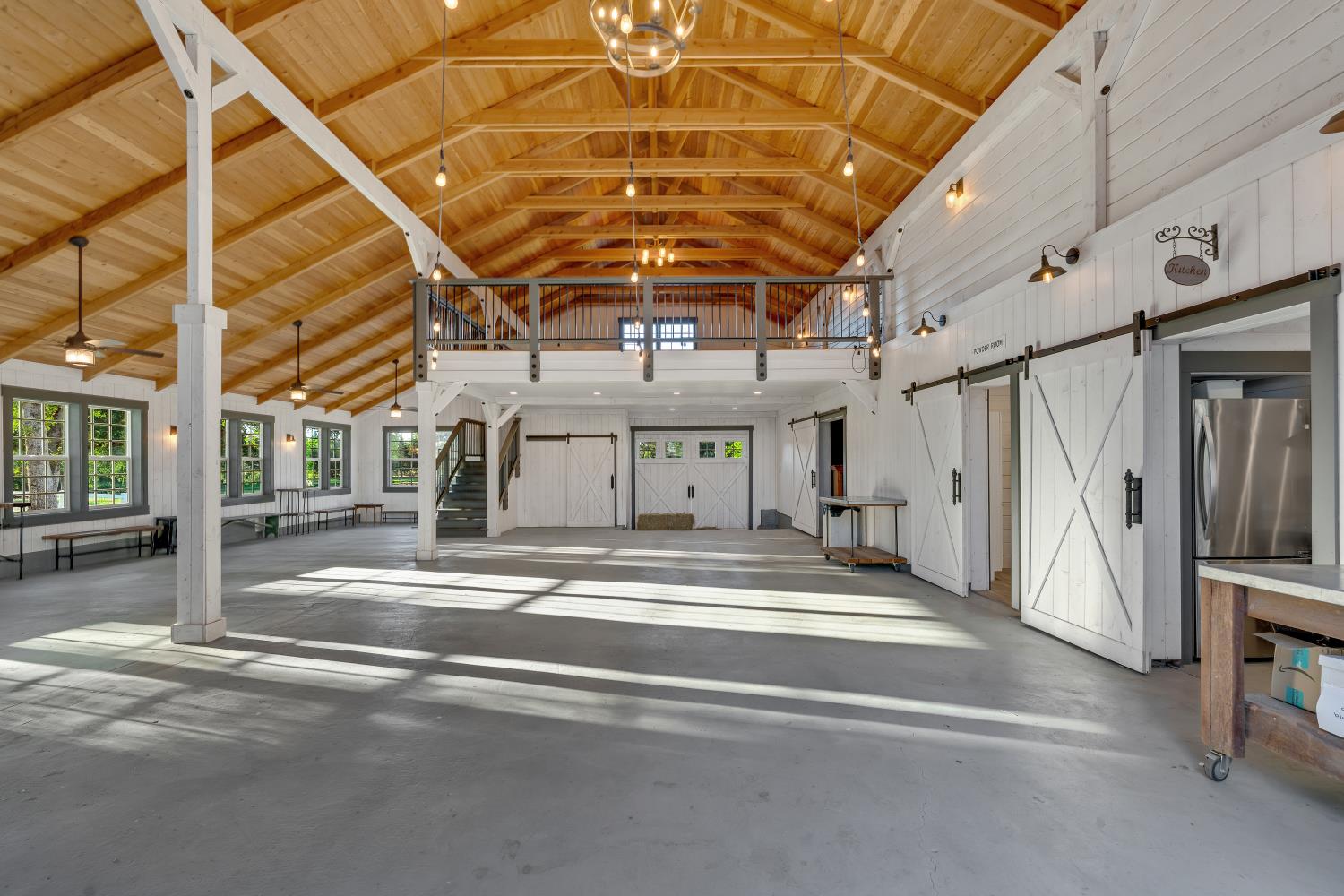 2905 Virginiatown Road Lincoln, CA 95648 - Photo 58 of 86 Spacious interior with high vaulted wood-finish ceilings, exposed white support beams, and light gray concrete flooring
