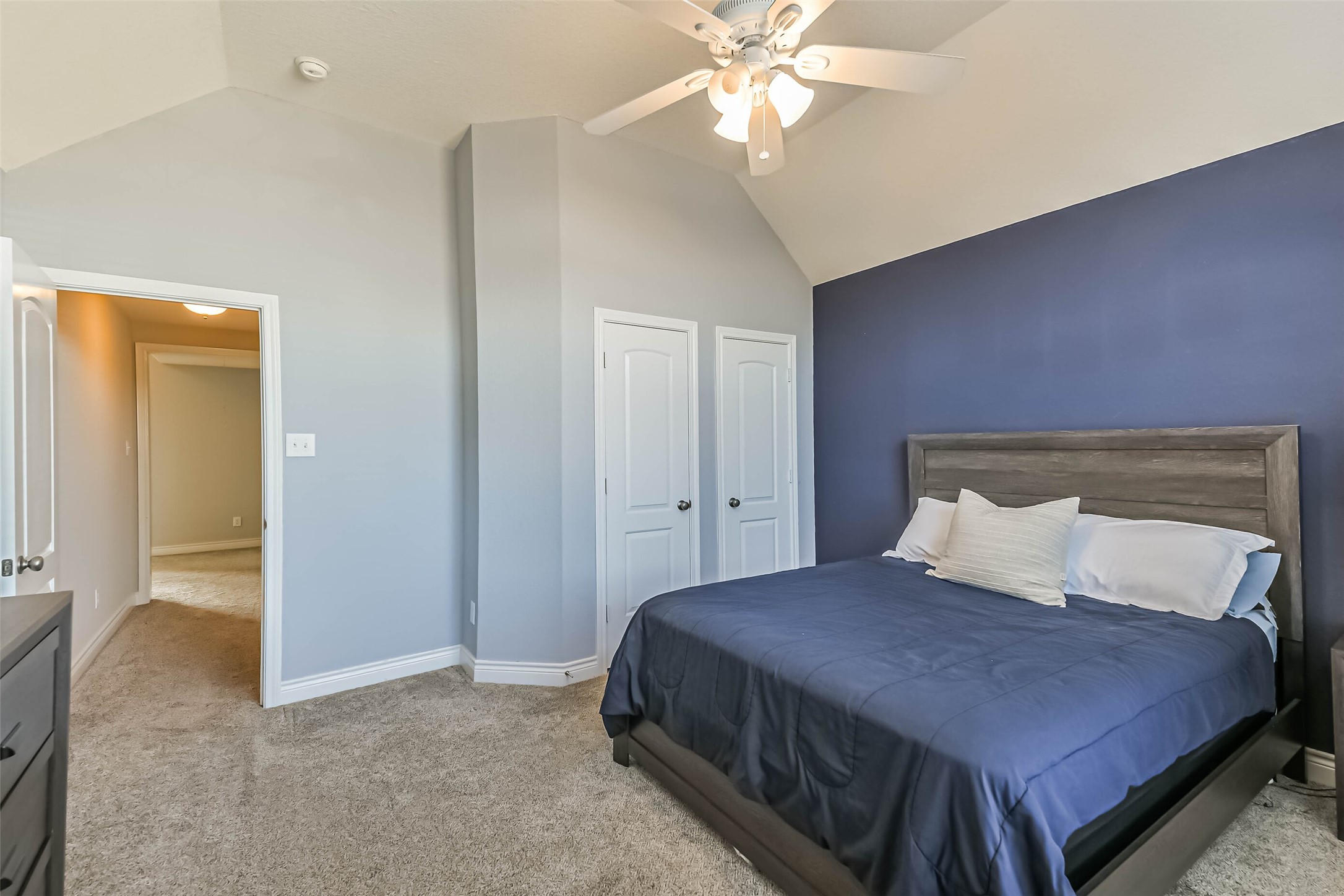 19022 Greenleaf Ridge Court Cypress, TX 77429 - Photo 35 of 47 a bedroom with a bed and a chandelier