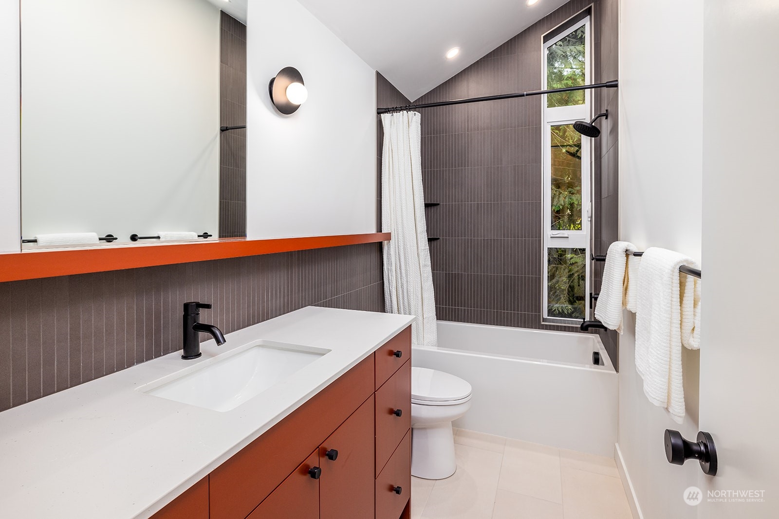 9019 8th Avenue Northeast Seattle, WA 98115 - Photo 12 of 14 a bathroom with a sink a toilet and shower