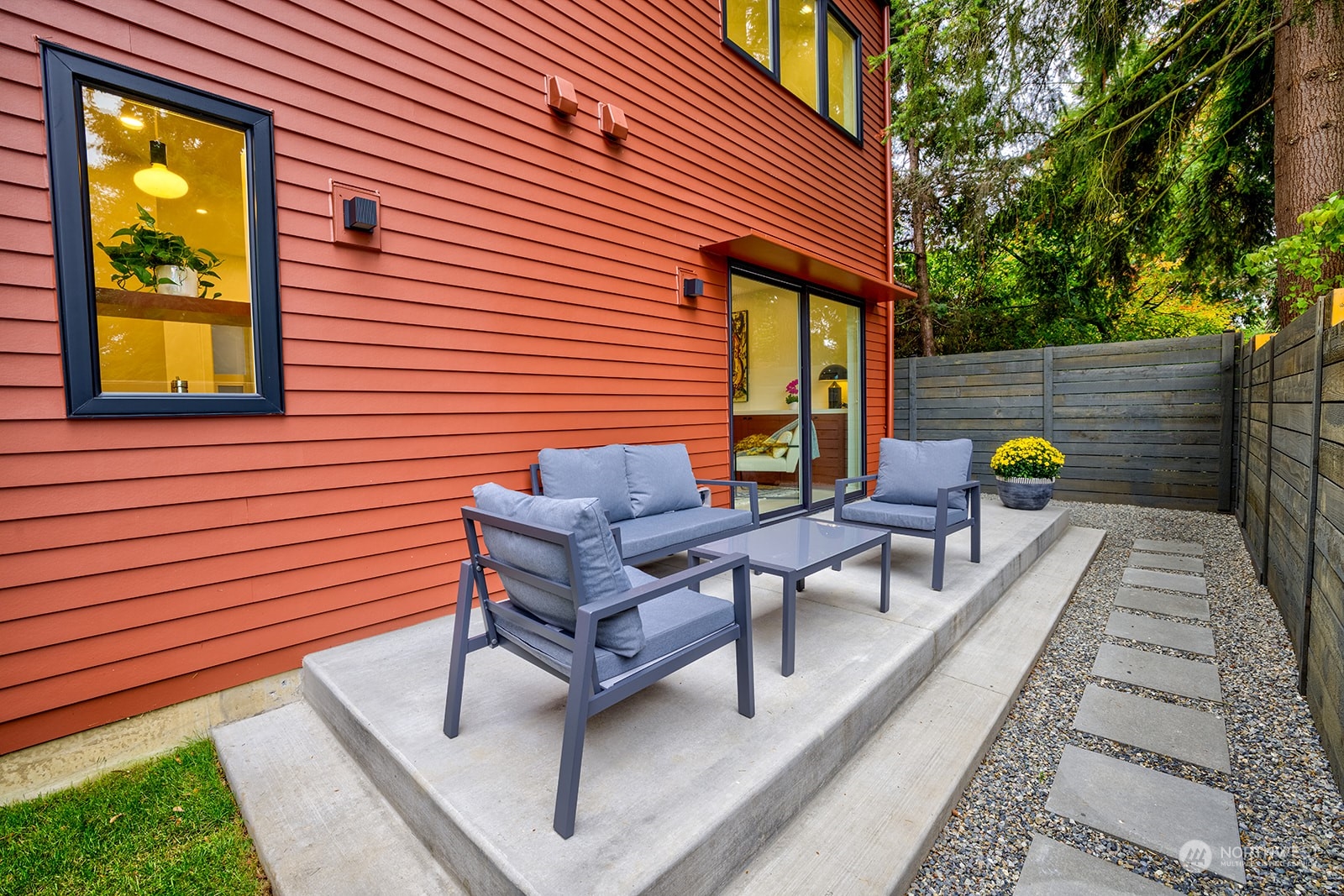 9019 8th Avenue Northeast Seattle, WA 98115 - Photo 13 of 14 a view of a patio with table and chairs with wooden floor and plants