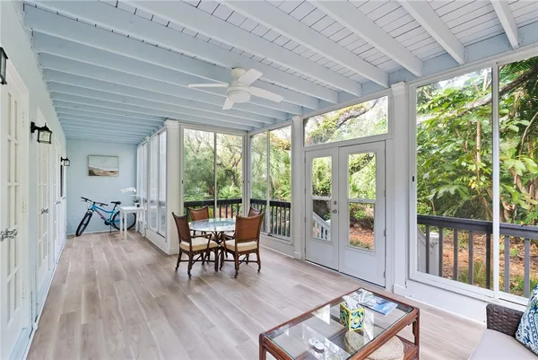 a living room with furniture and floor to ceiling windows