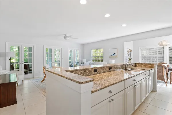 a dining hall with stainless steel appliances granite countertop a sink and dishwasher with a granite countertops