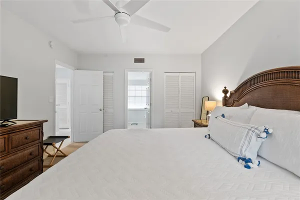a bedroom with a bed and a computer on the desk