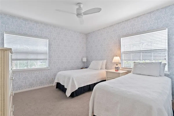 a bedroom with two beds and a window