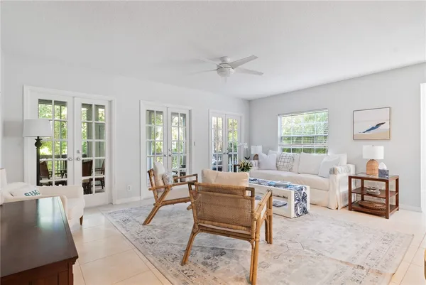 a living room with furniture two window and a table
