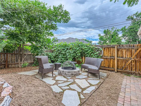 a view of a chairs and table in backyard